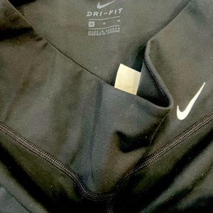 Women’s Nike 3/4 length tight. Black with gold & white embellishments size: med